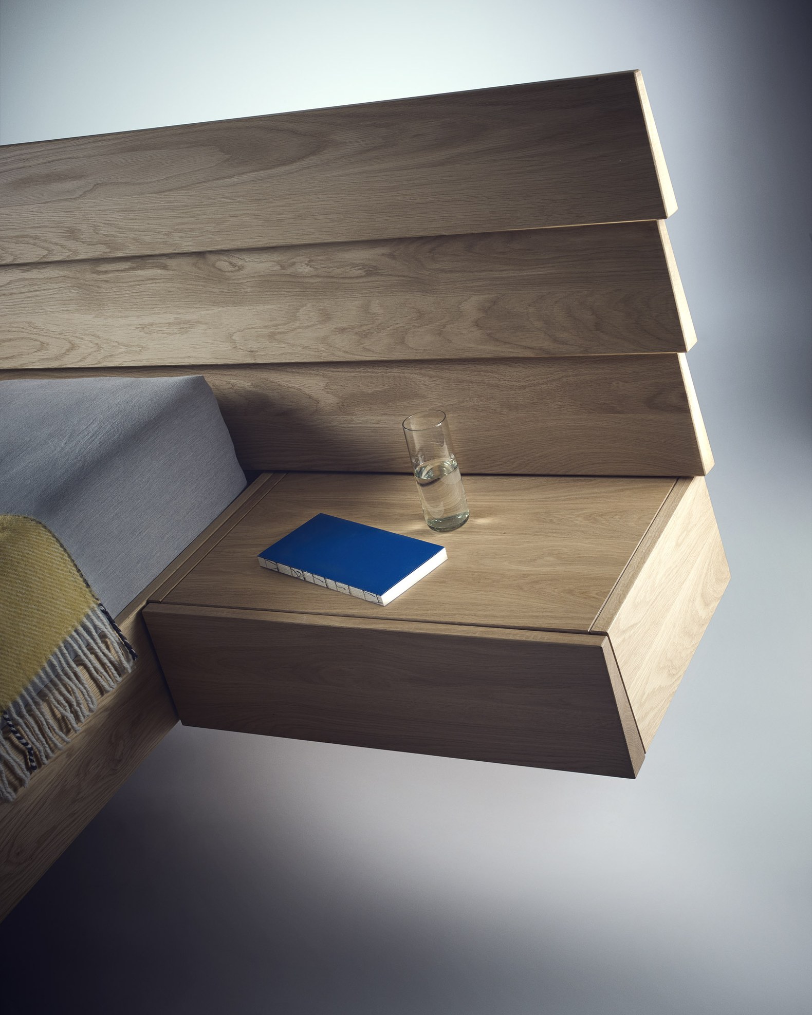 Solid oak bed with a floating bedside table in the BeOak Bratislava showroom