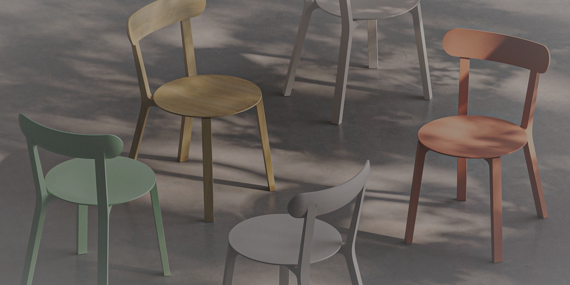 Five dining chairs in oak and painted finishes on a sunlit concrete floor